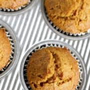 overhead shot of a fresh batch of pumpkin muffins in corregated muffin pan