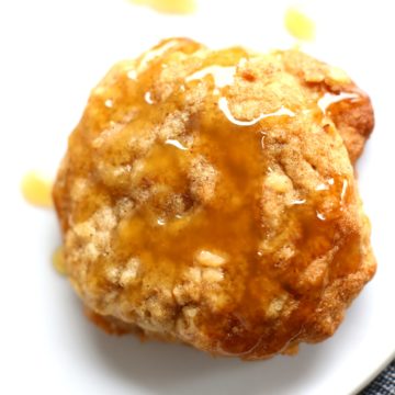 sea salt caramel apple oatmeal cookies with caramel drizzeled on top. Served on a white plate with denim napkin