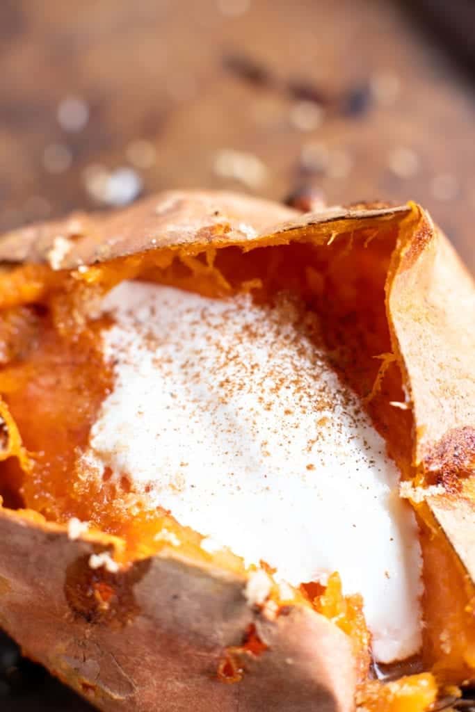 up close picture of baked sweet potato on baking sheet cut in half with melting butter and creamy marshmallow fluff sprinkled with sea salt and brown sugar then dusted with cinnamon! #feedfeed #f52grams #BuzzFeast #SWEEEEETS #huffposttaste #ImSoMartha #surlatable #mywilliamssonoma #thekitchn #eeeeeats #bhgfood #eattheworld #bakersofinstagram #christmassides #foodandwine #foodgawker #bareaders #fwx #ABMfoodie #beautifulcuisines #holidaysides #eatingfortheinsta #foodwinewomen #yahoofood #foodblogfeed #foodblogeats #theeverygirl #thatsdarling #dailyfoodfeed #foodphotography #foodblogeats #loadedbakedpotato #sweetpotato #sides #easysides #easyrecipes #bingeworthybites