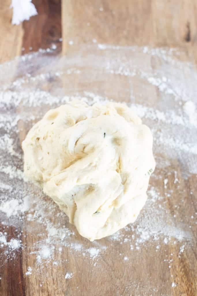 garlic pita bread dough on floured surface 