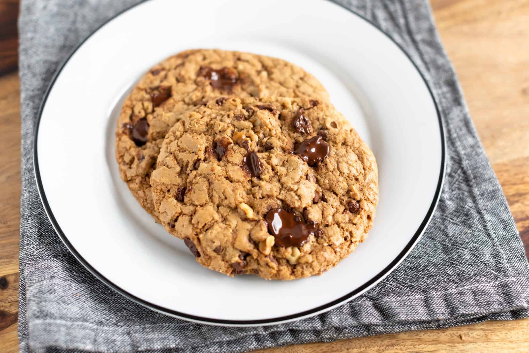 DoubleTree's Signature Chocolate Chip Cookie served on white dish with black rim and denim napkin #cookie #chocolatechipcookie #doubletreesignaturecookie #baking