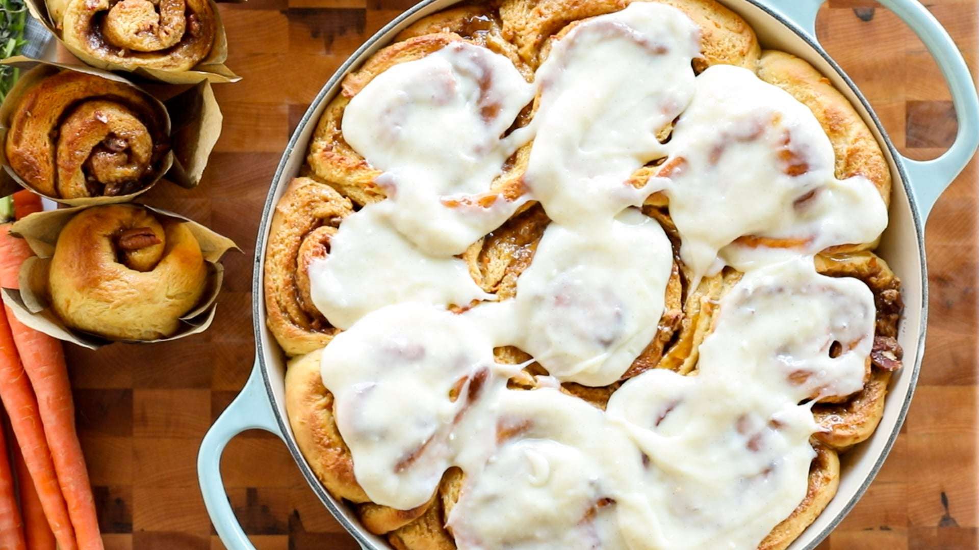 caramel pecan cinnamon rolls out of the oven, brushed with caramel and iced- ready to serve!