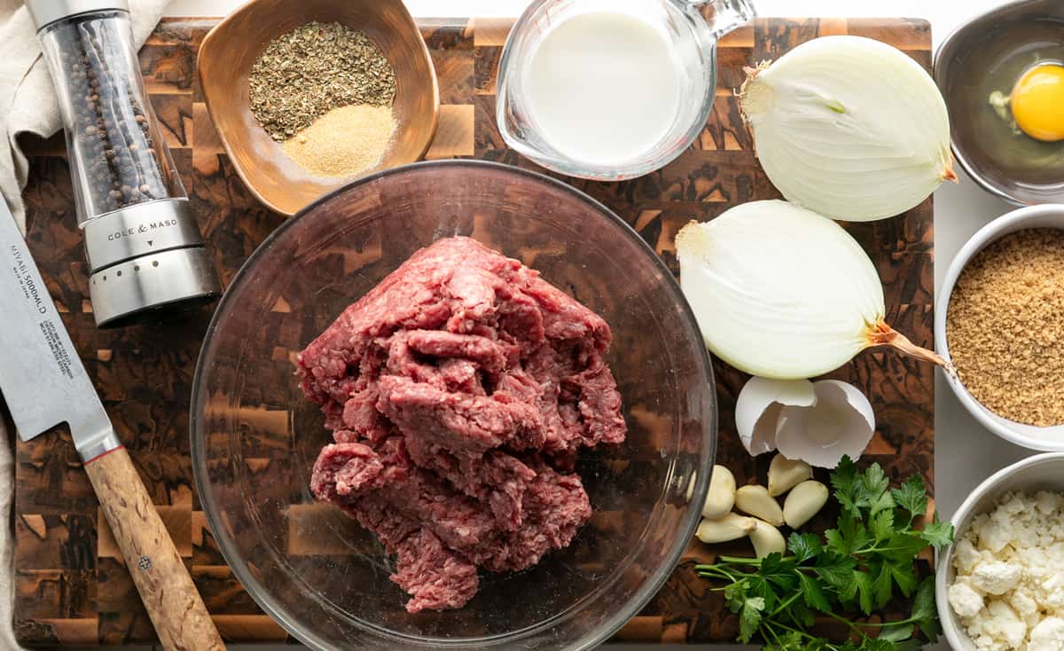 Ingredients for Greek Meatballs (Keftedes): Ground beef, pepper, milk, oregano, granulated garlic, fresh garlic, panko bread crumbs, feta, parsley, egg, onion